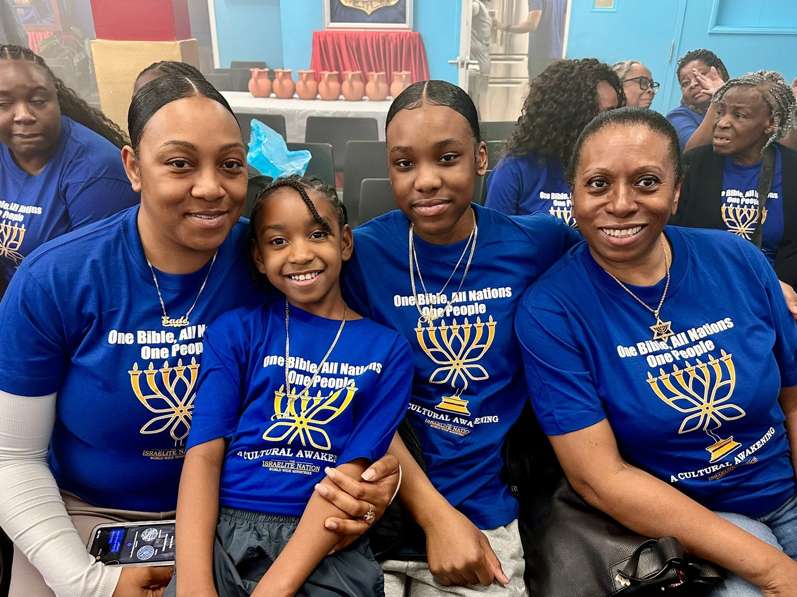 Members of the congregation smiling together in blue Nation shirts.