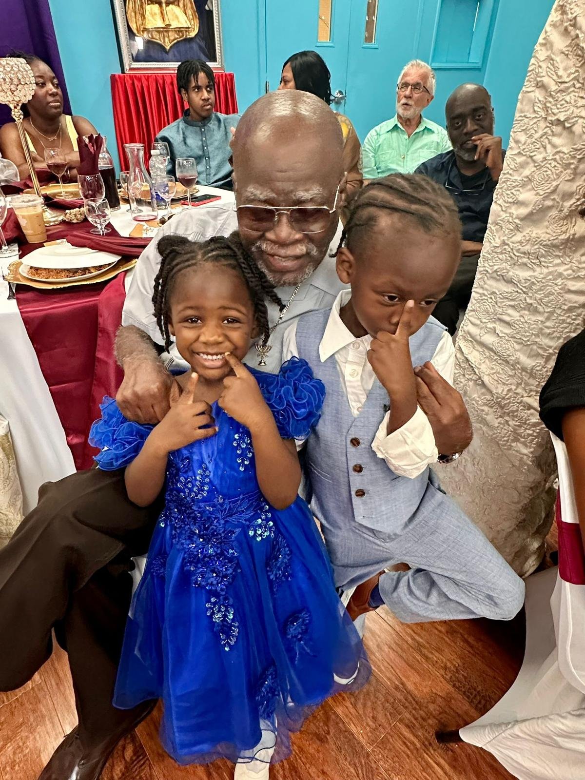 Elder Shadrock with two children of the nation at a celebration.
